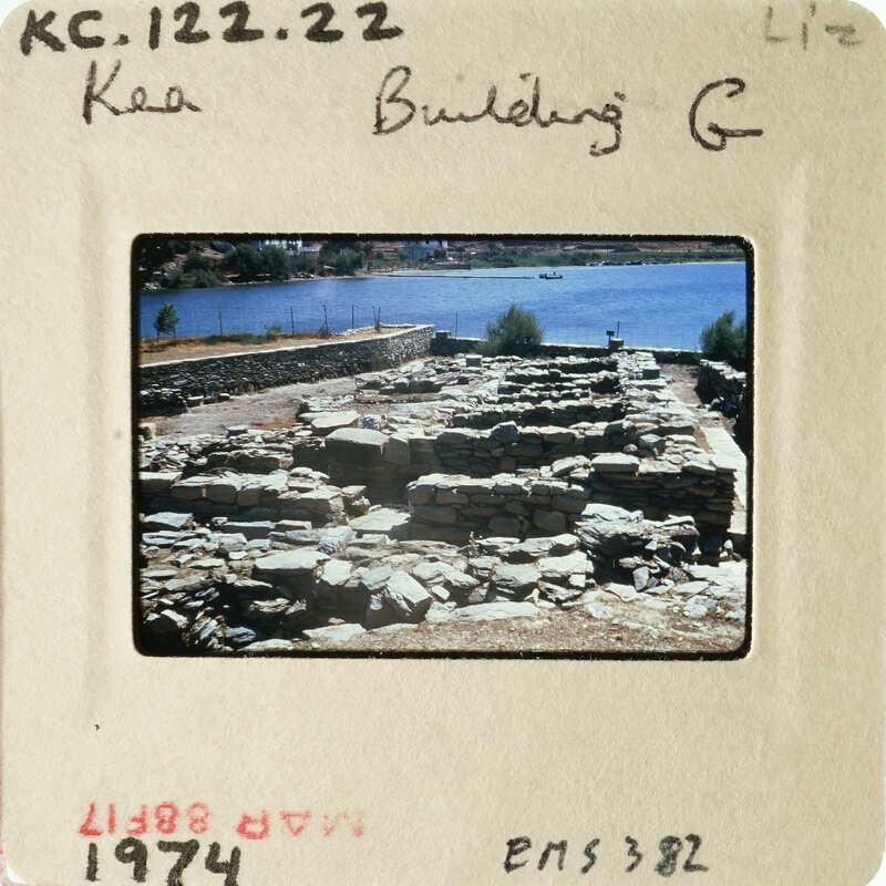 A photograph of an ancient archaeological site with ruins and water in the background.
