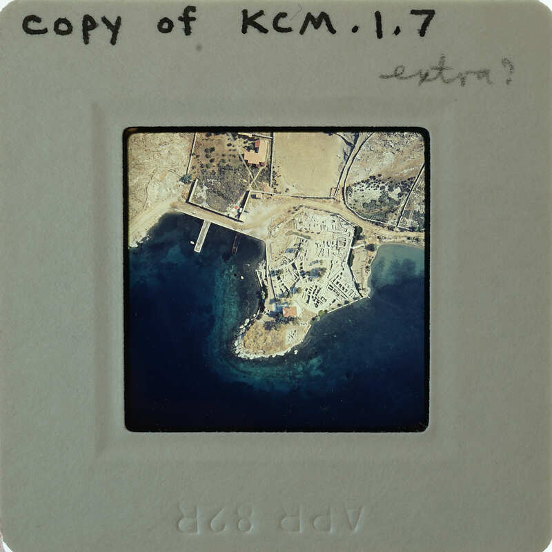 Aerial photo of a coastal area on a film strip labeled "KM17" with handwritten notes.