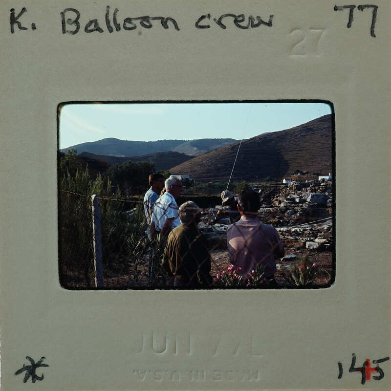 Old photograph of a balloon crew with mountains in the background.