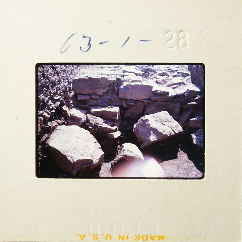 Rocky landscape with large boulders and vegetation.