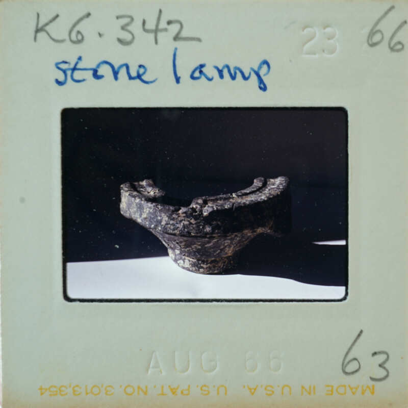 A photograph of a stone lamp with a vintage Polaroid border.