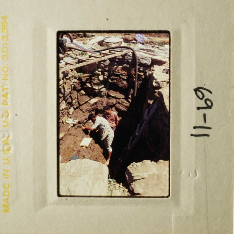 A photo of a person working on a construction site, surrounded by rubble and debris.