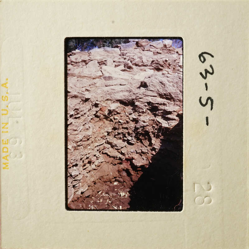 A photograph of an outdoor scene with rocks and dirt, possibly from a geological study or fieldwork.