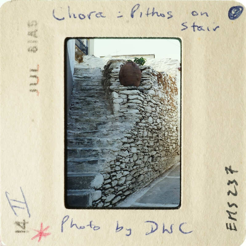 Old stone stairs with a wall made of stacked stones.