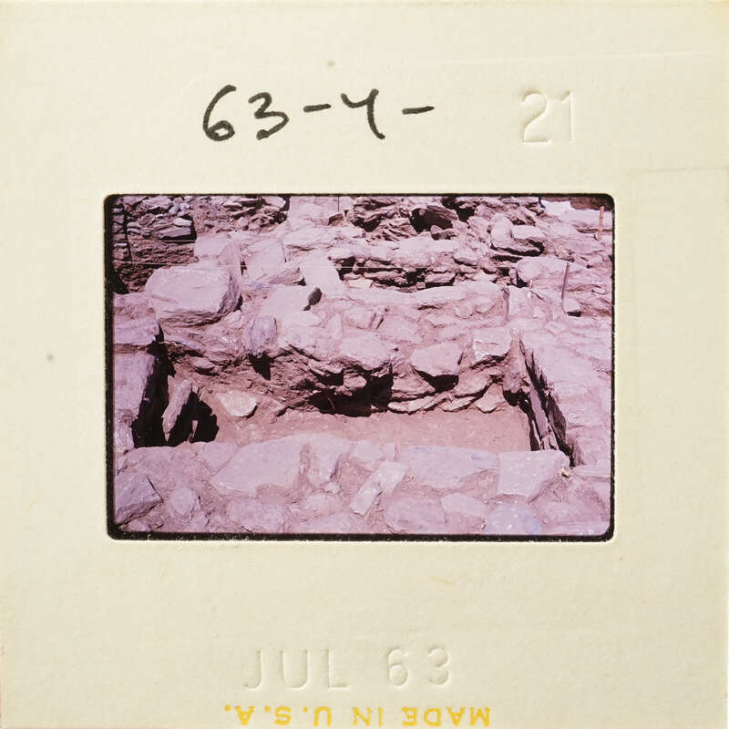 A photograph showing an excavation site with rock formations and dirt, possibly part of an archaeological dig.