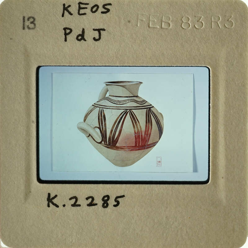 The image shows an antique vase with intricate designs, photographed against a white background.