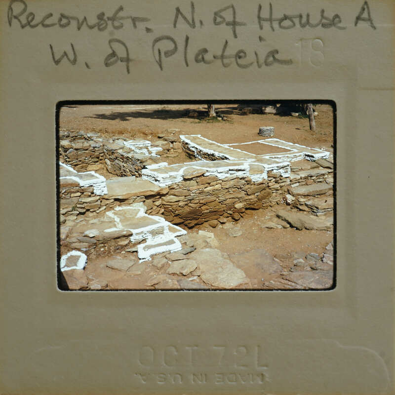 A photograph of an archaeological site with stone ruins and markings, possibly taken by a researcher or archaeologist.