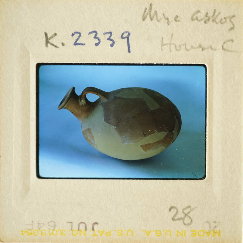 A photograph of an ancient ceramic jar with visible cracks and chips.