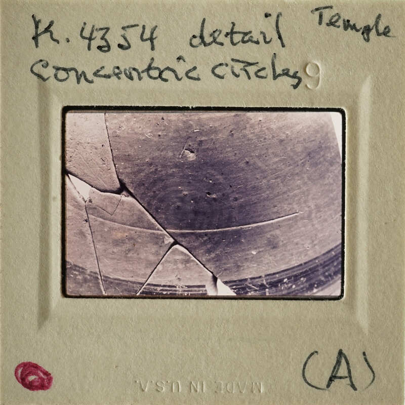 A photograph depicting an ancient artifact with visible cracks and details.