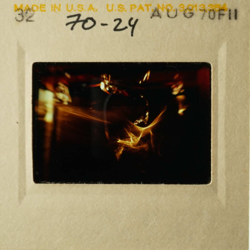 This is an old photo of a person holding a camera.