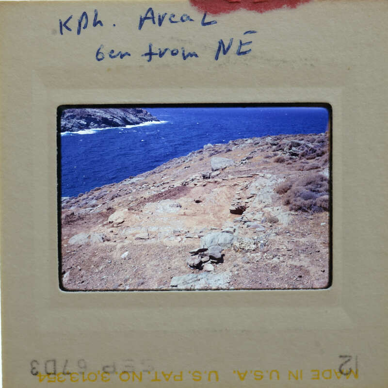 A slide of a rocky cliff overlooking the ocean with handwritten notes on the border.