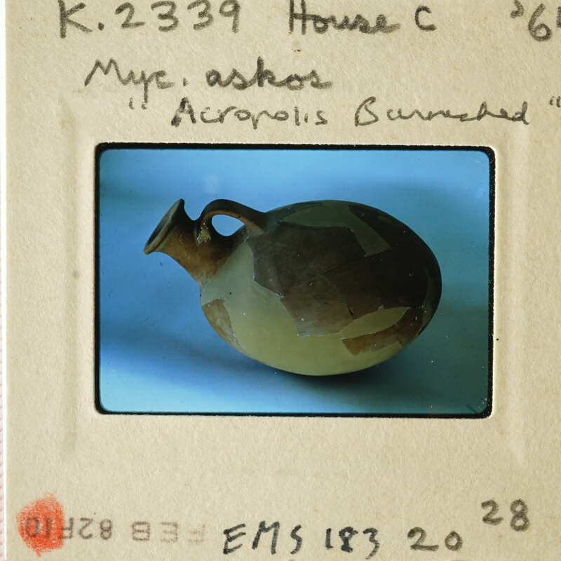 Ancient Greek amphora on display with label.