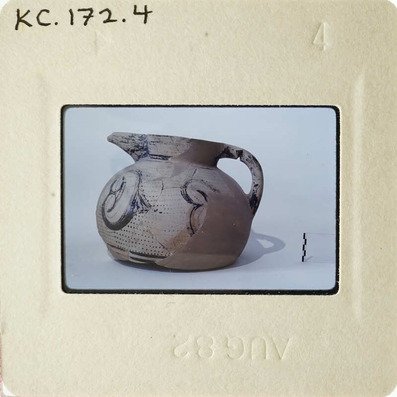 This is an image of a clay pot with markings on it, photographed against a white background.