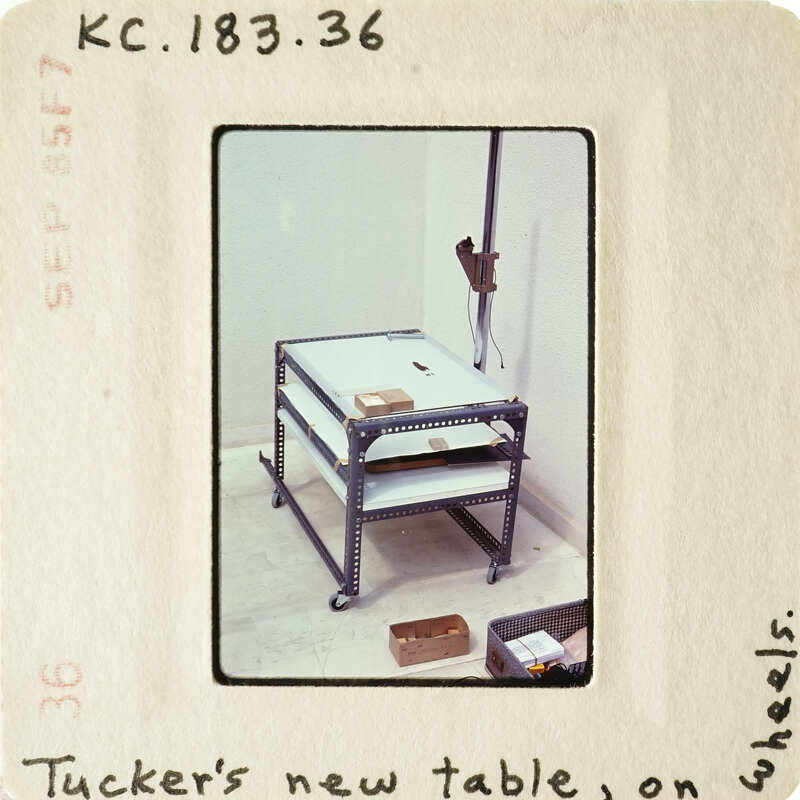 A metal workbench with shelves and tools on the floor.