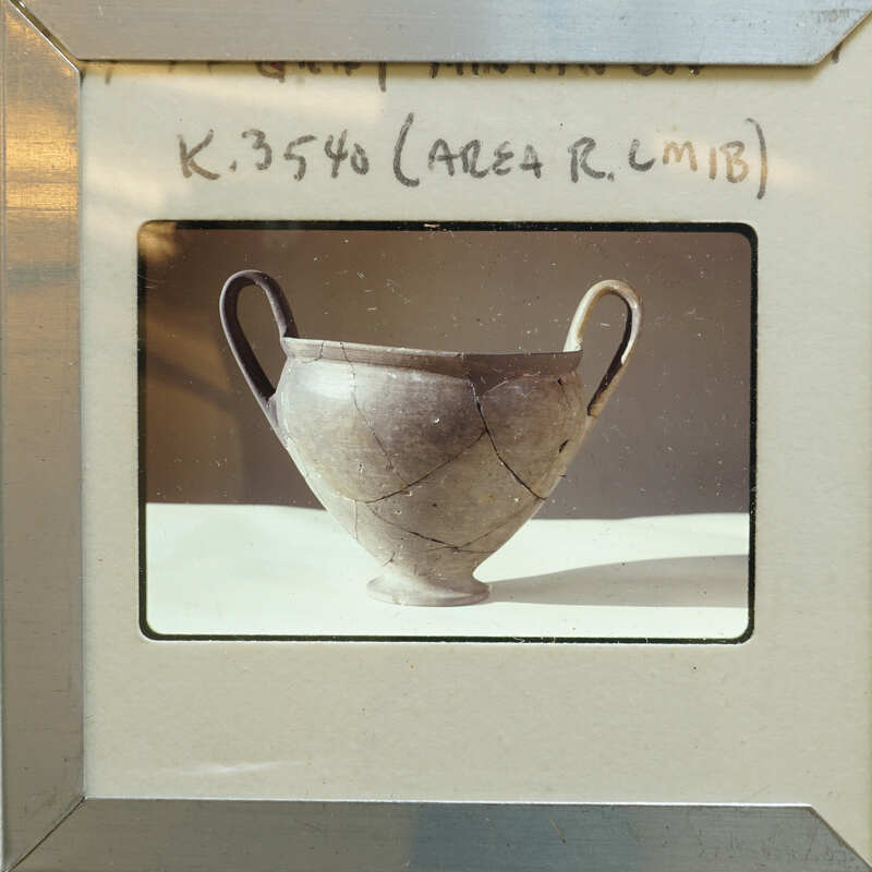 Broken and repaired ancient Greek vase (K.3540) on display.