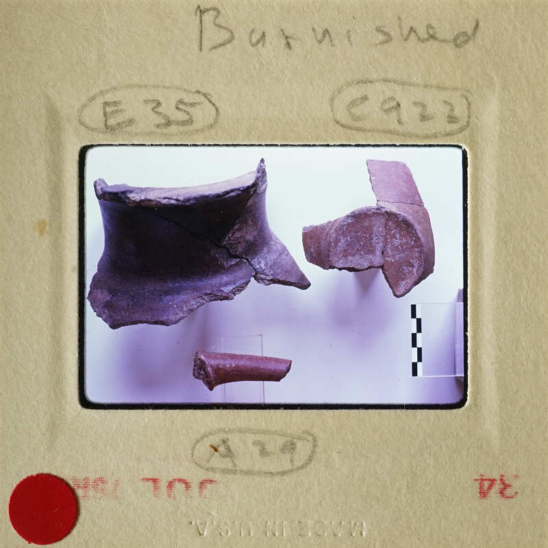 Old broken pottery pieces on display.