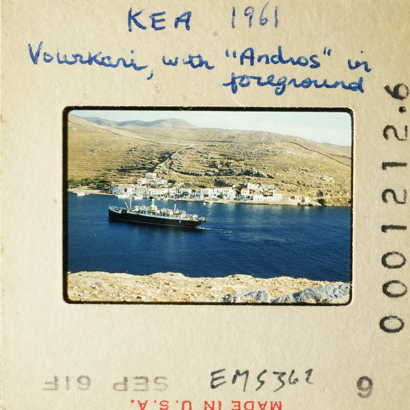 A photograph of an island with houses and boats on the water, taken from a high vantage point.
