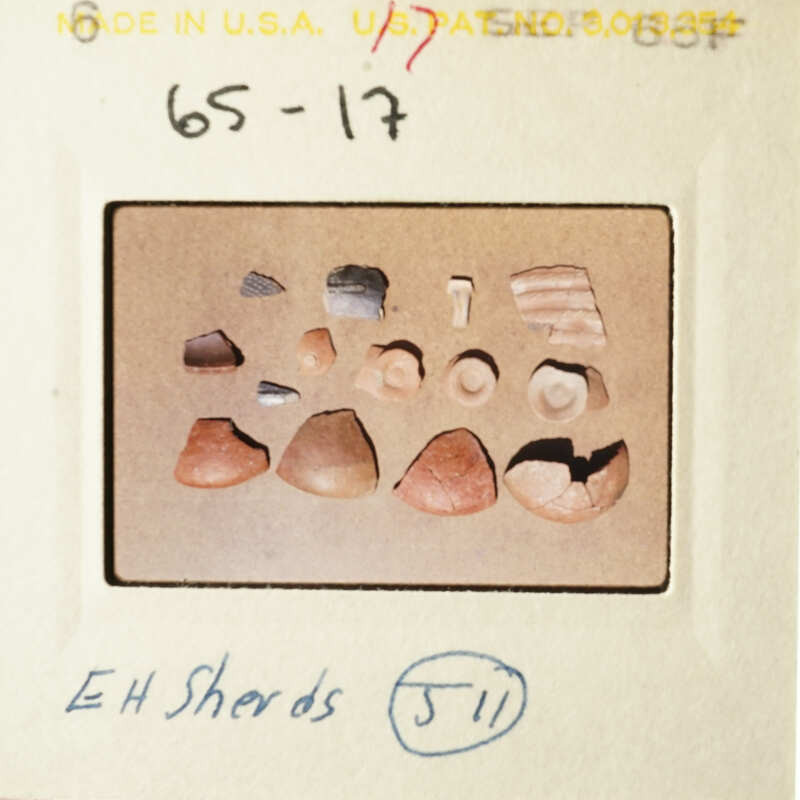 The photo shows a collection of small, broken objects on a table.