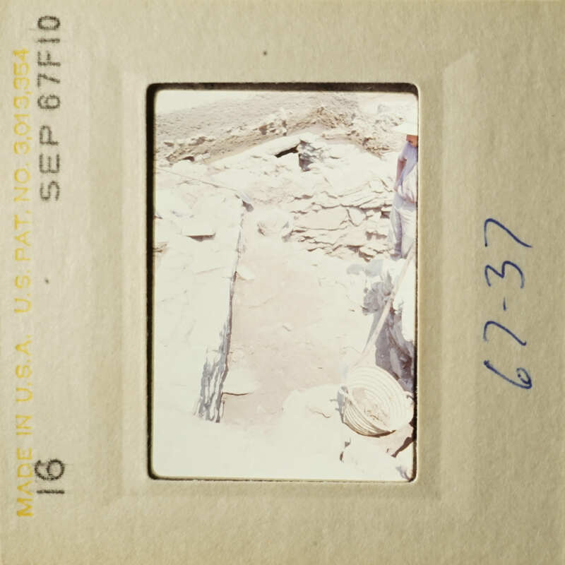 A photo of a destroyed building with rubble and debris, taken from an elevated angle.