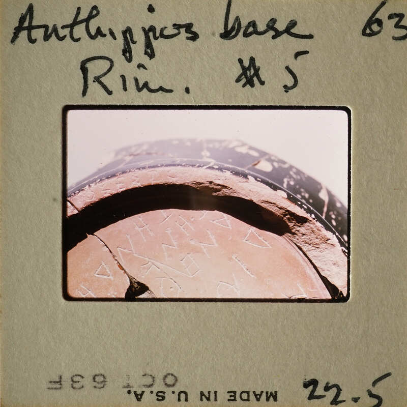 Ancient Greek vase with visible writing and markings.