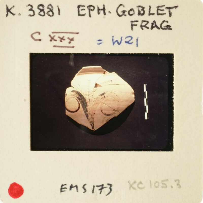 A photograph of an ancient artifact, possibly a stone carving with markings and symbols.