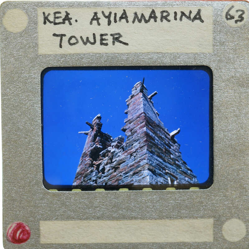 Old photo of a tower with a blue sky background.