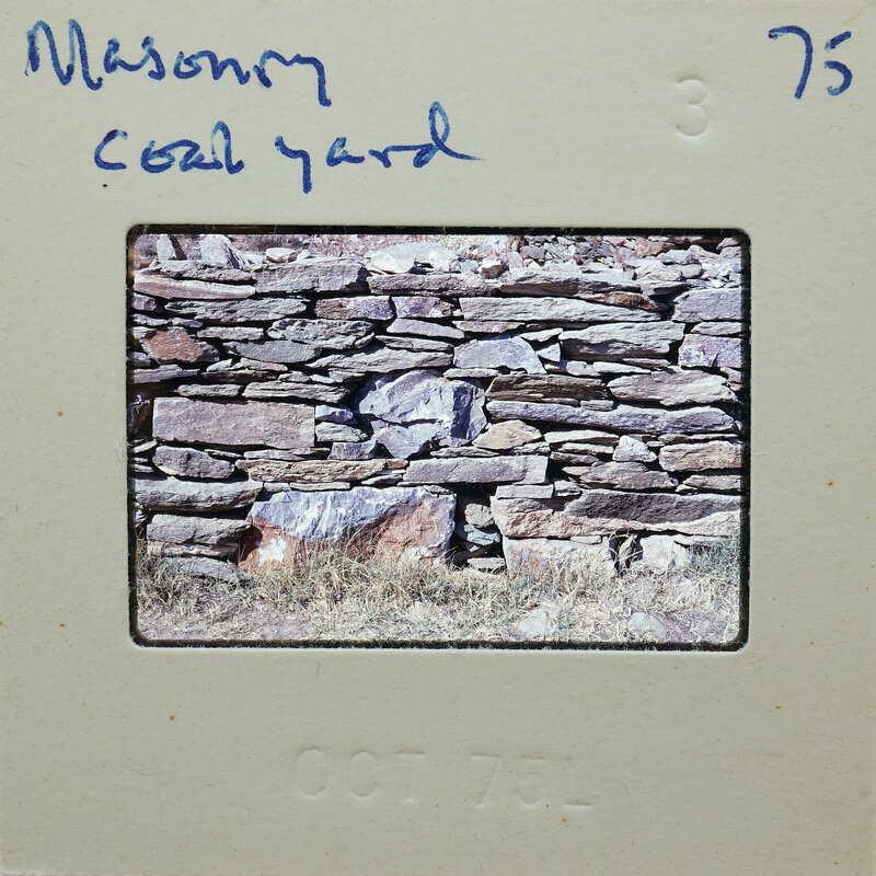 Old photograph of a stone wall with grass, dated October 1976.