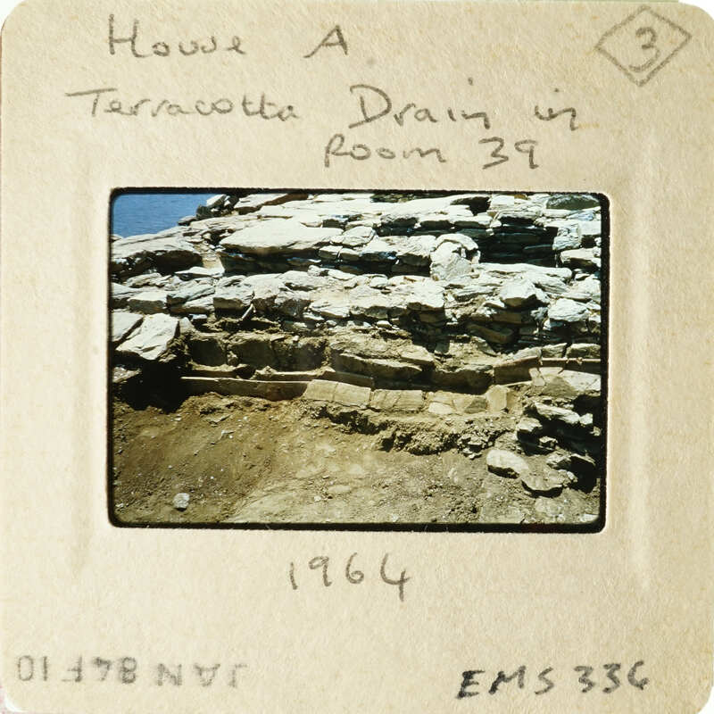 Old photograph of an ancient wall with visible layers and textures, dated 1964.