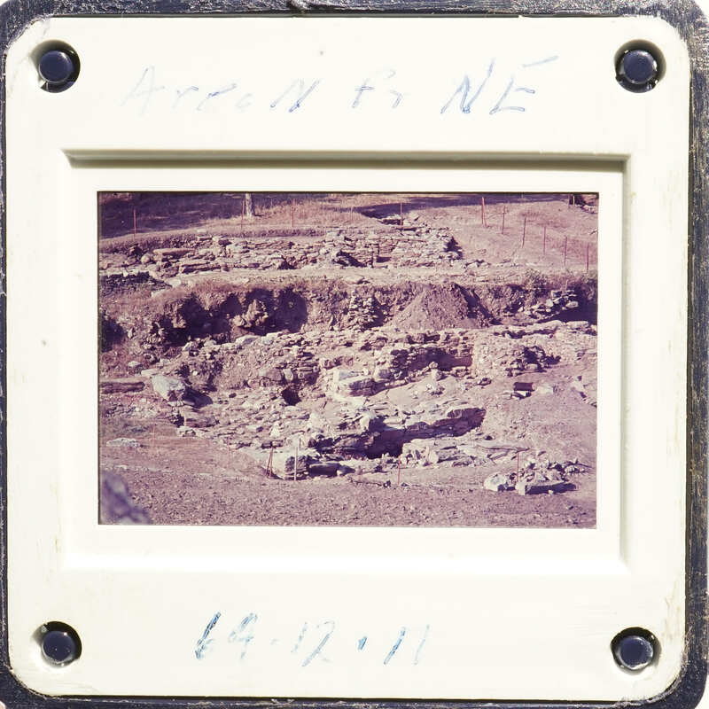 This is an old photograph showing excavated ruins with visible stone structures and foundations.