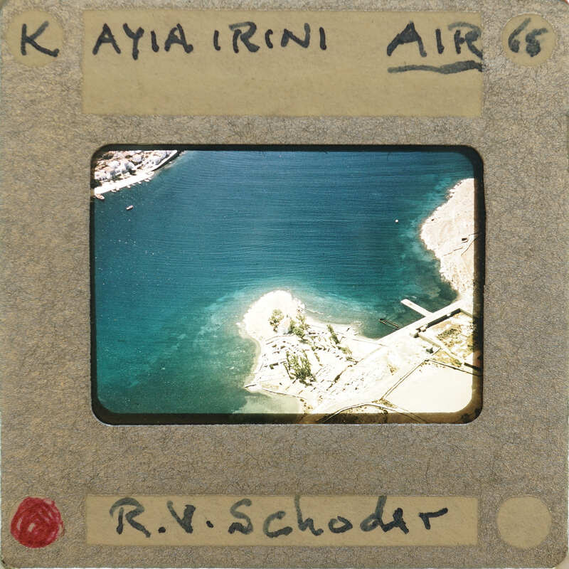 Aerial photograph of a coastal area with water and land.