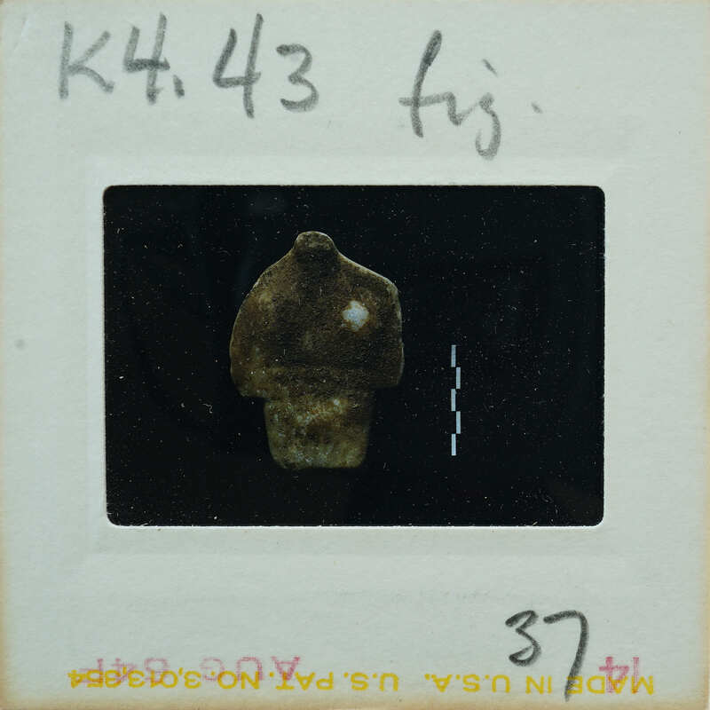 Torso of marble figurine from front.