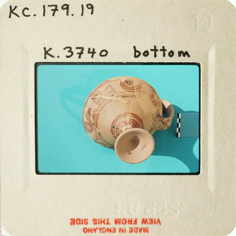 Ancient ceramic pot with intricate designs on a blue background.