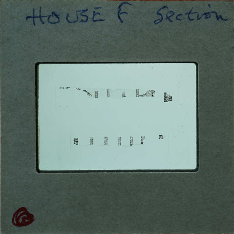 A close-up image of a film strip with visible sprocket holes and perforations.