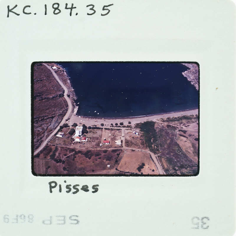 Aerial photo of a lake with land formations and structures, labeled "Pisses" on the film strip.