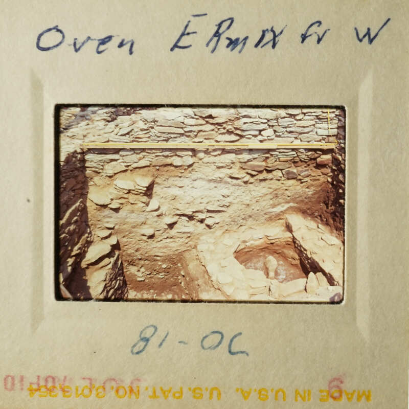 The image shows an archaeological site with stone structures and artifacts, possibly from an ancient civilization.