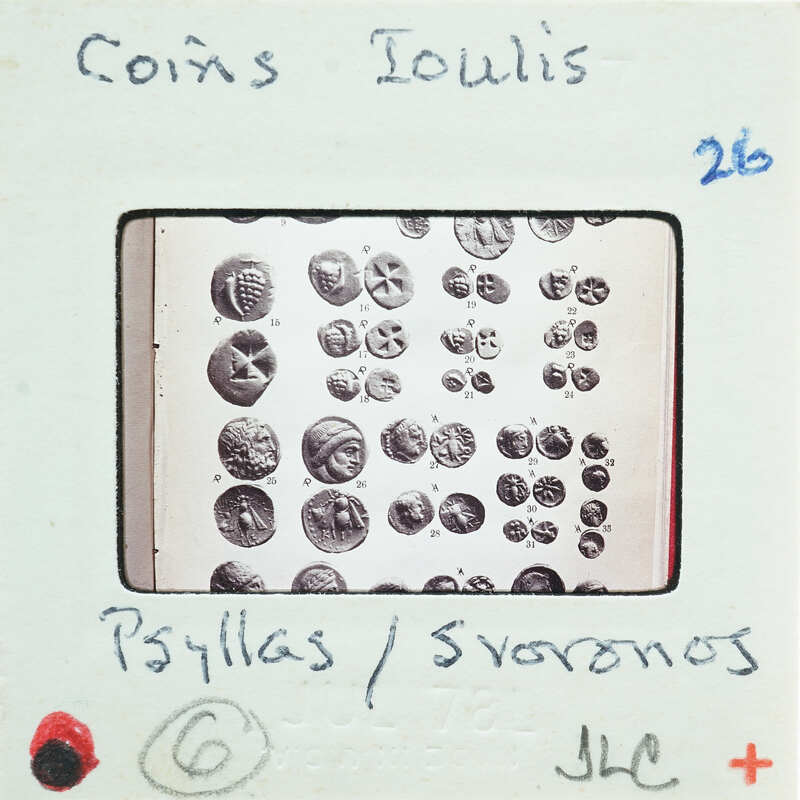 Image of a coin collection with labels and numbers on a card.