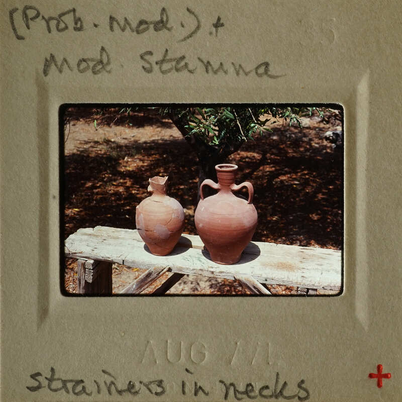 Two clay vases on a wooden surface.