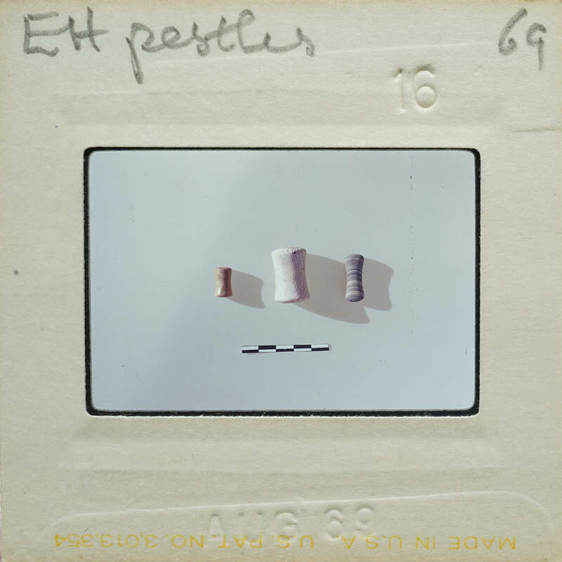 Three cylindrical items on table.