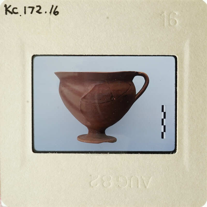 A photograph of an ancient Greek amphora with visible cracks and wear, displayed against a white background.