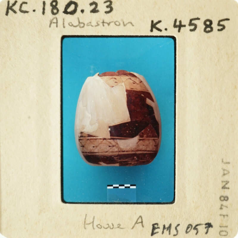 A photograph of an antique object with a label underneath.
