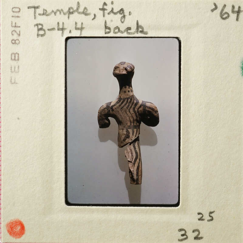 Ancient sculpture with intricate patterns and designs, displayed against a white background.