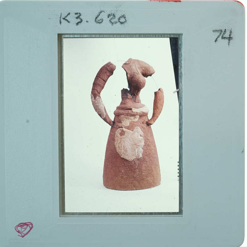 Partially restored figurine on white background.