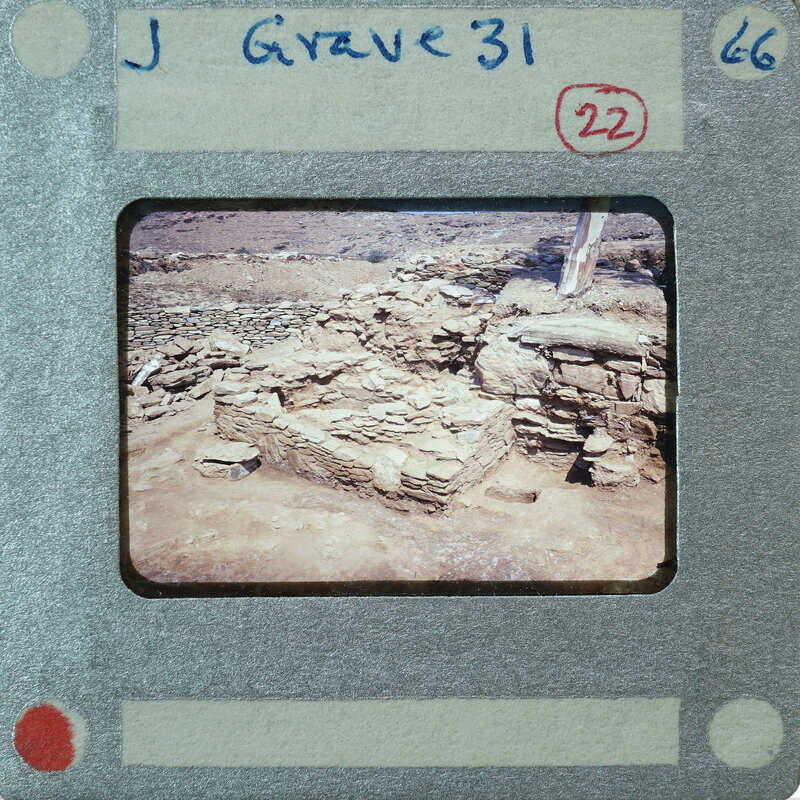 The image shows a vintage photograph of an archaeological site with stone ruins, enclosed within a film strip border.