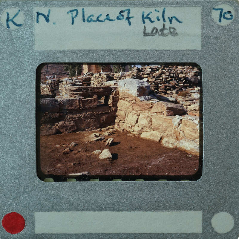A photograph of an old stone structure with a film strip border and writing on it.
