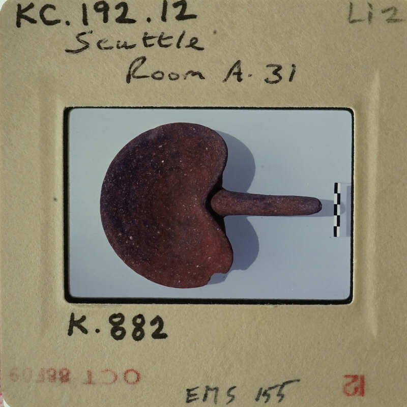 Old photograph of an object, possibly a tool or artifact, with visible wear and tear.