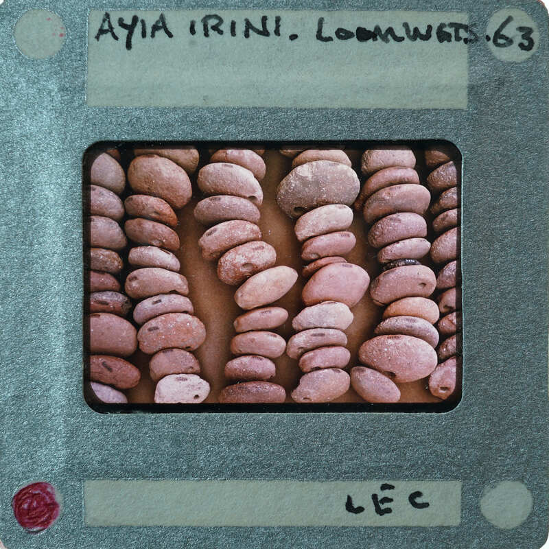 Stacked circular lentoid clay objects upright.