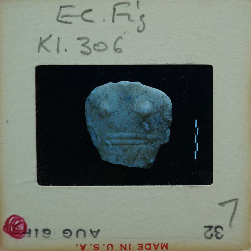 Torso of stylized marble figurine.