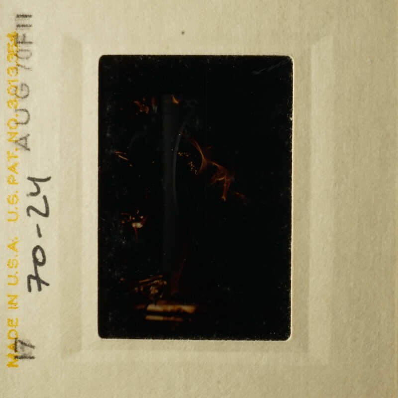 This is an image of a vintage film strip with a dark, blurry photograph of a person.