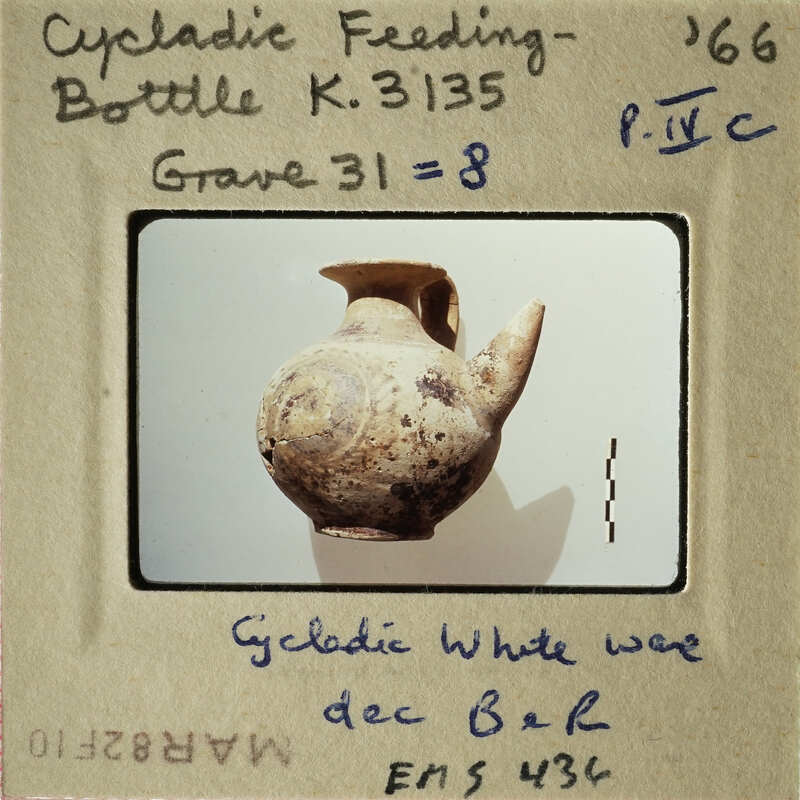 Ancient ceramic vase with label indicating its origin and type.