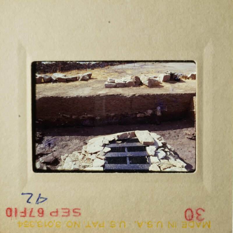 The photo shows an outdoor scene with a stone structure and some rocks in the foreground.